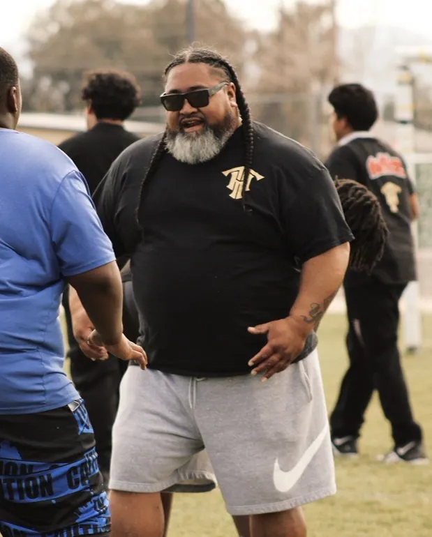 Trench House coach working with athletes at a field session